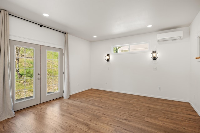 16717 E Washington Rd, Valleyford, WA 99036 - empty room featuring a wall mounted AC, french doors, plenty of natural light, and recessed lighting