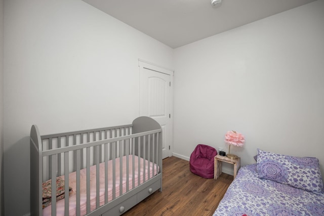 bedroom with baseboards and wood finished floors