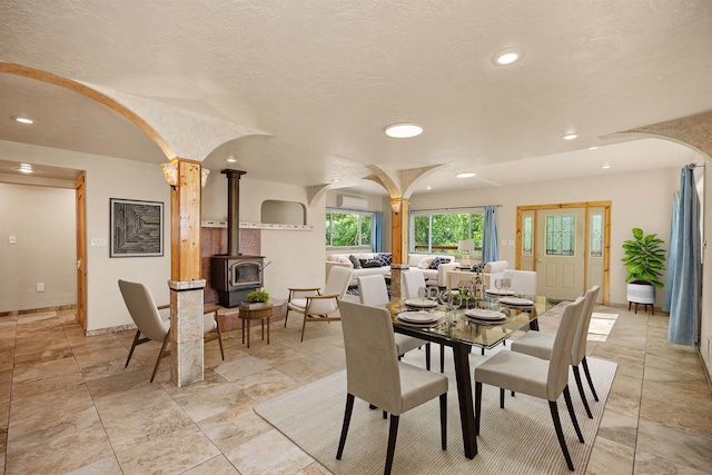16717 E Washington Rd, Valleyford, WA 99036 - dining space featuring arched walkways, a wood stove, and recessed lighting