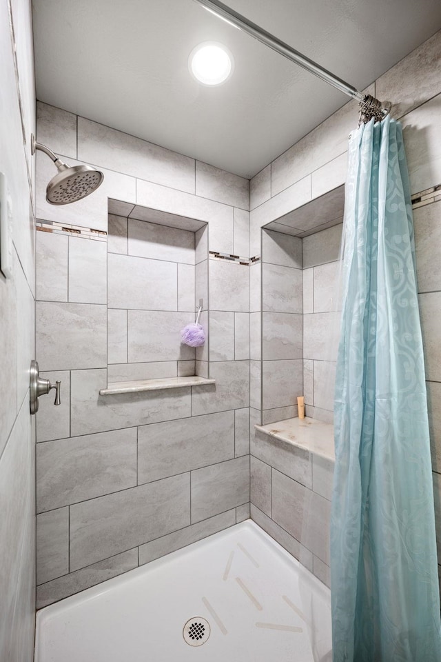 bathroom with a tile shower