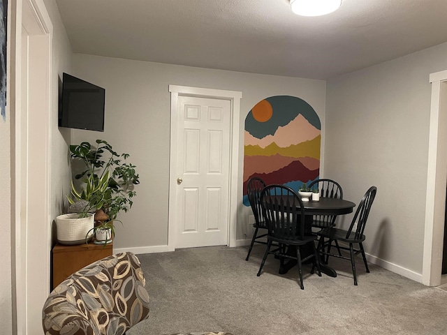 dining space featuring baseboards and carpet floors
