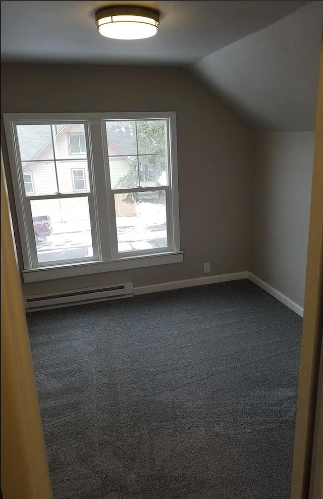 additional living space with carpet, baseboards, lofted ceiling, and a baseboard radiator