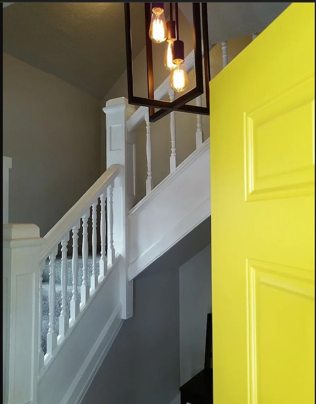 stairway with lofted ceiling