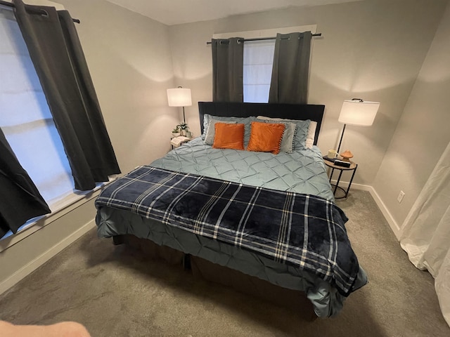 carpeted bedroom featuring baseboards