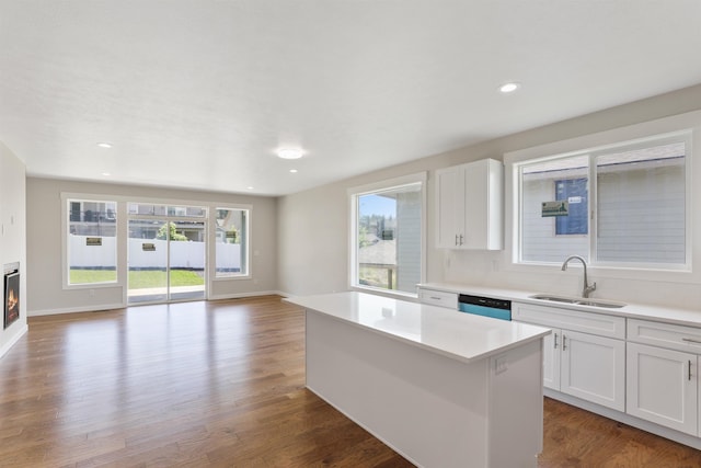 2623 S Vera Crest Dr, Spokane Valley, WA 99037 - kitchen with a sink, wood finished floors, dishwasher, a center island, and a glass covered fireplace