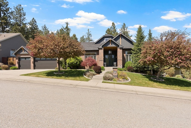 craftsman-style house featuring driveway, board and batten siding, brick siding, a garage, and a front lawn