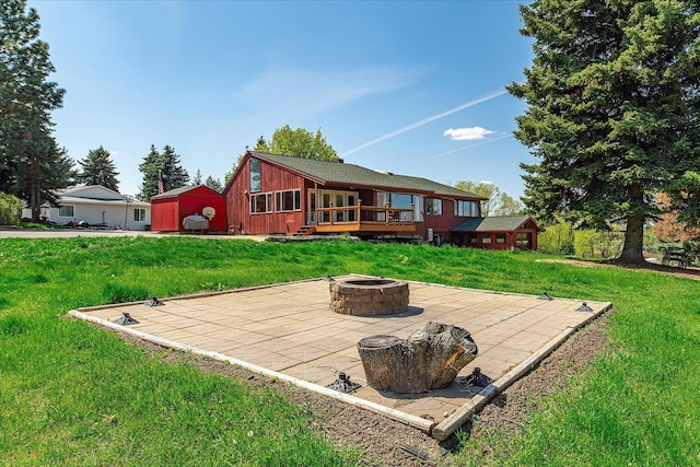 406 N Northridge Way, Fairfield, WA 99012 - back of property featuring a fire pit, a patio area, a deck, and a lawn