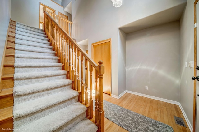 2712 W Eden Ln, Deer Park, WA 99006 - staircase featuring baseboards, visible vents, a high ceiling, and wood finished floors