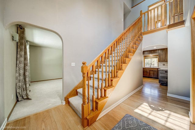 2712 W Eden Ln, Deer Park, WA 99006 - stairs with arched walkways, baseboards, and wood finished floors