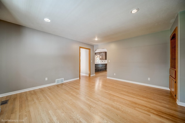 2712 W Eden Ln, Deer Park, WA 99006 - empty room featuring visible vents, light wood-style flooring, baseboards, and arched walkways