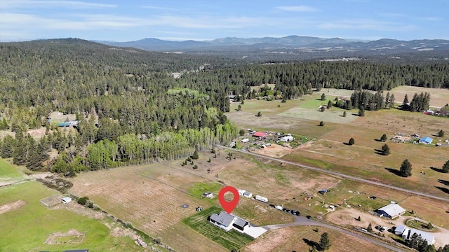 32715 N Elk Chattaroy Rd, Chattaroy, WA 99003 - view of property location with a heavily wooded area and a mountainous background