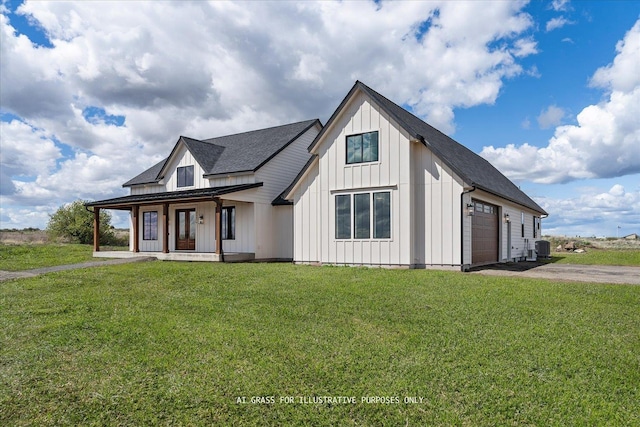 modern farmhouse style home with covered porch, board and batten siding, asphalt driveway, and a front lawn