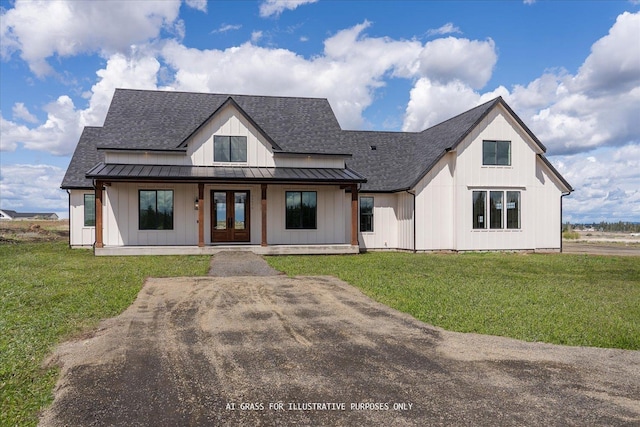 modern farmhouse with french doors, a standing seam roof, roof with shingles, and a front lawn