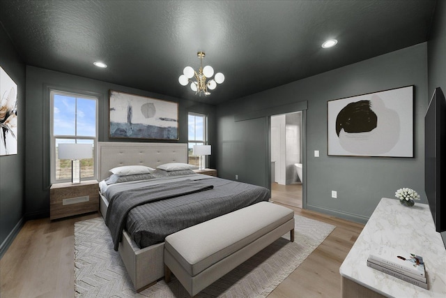bedroom featuring a chandelier, light wood finished floors, baseboards, ensuite bath, and recessed lighting