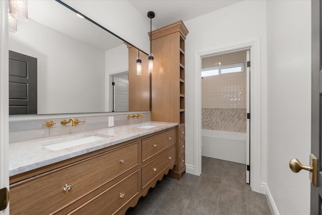 full bath with double vanity, a tub to relax in, and tile patterned floors