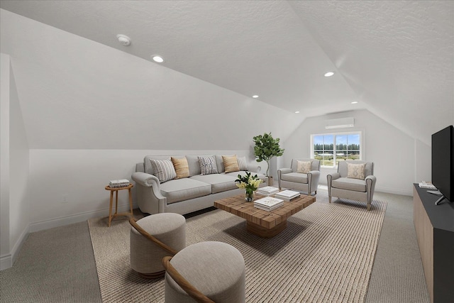 carpeted living room featuring a wall unit AC, vaulted ceiling, baseboards, recessed lighting, and a textured ceiling