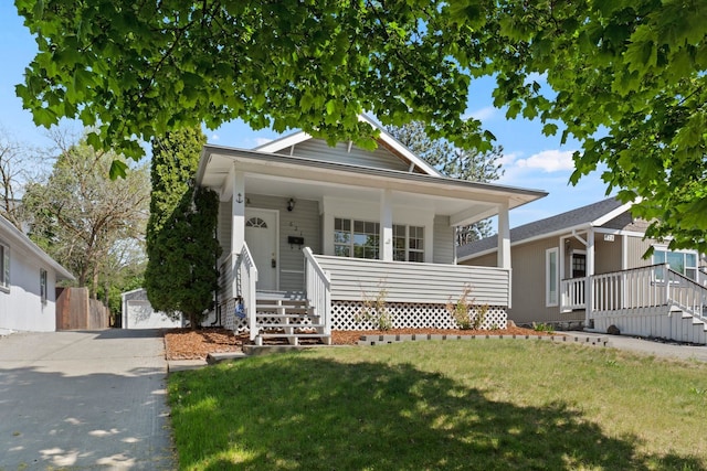 view of front of house with a porch, a front lawn, and stairway