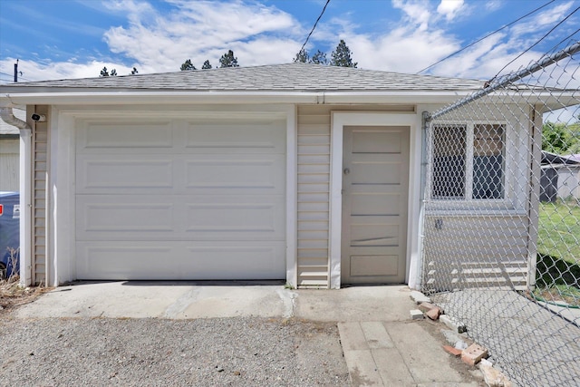 detached garage featuring fence