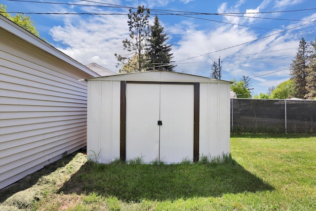 view of shed with fence