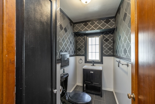 bathroom featuring toilet, tile patterned flooring, vanity, and wallpapered walls