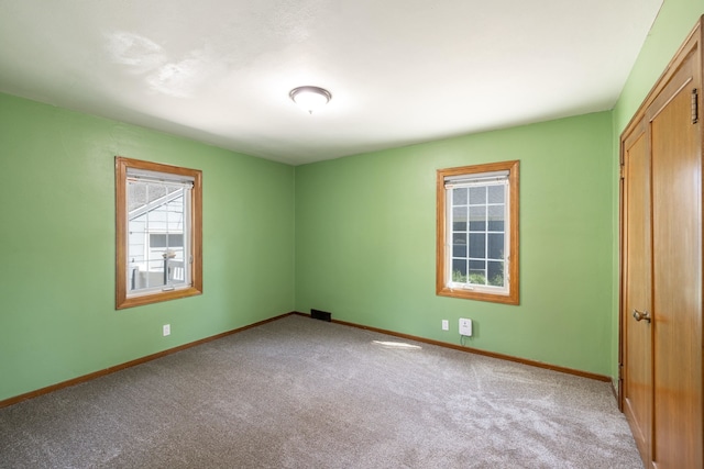 unfurnished bedroom featuring carpet flooring and baseboards