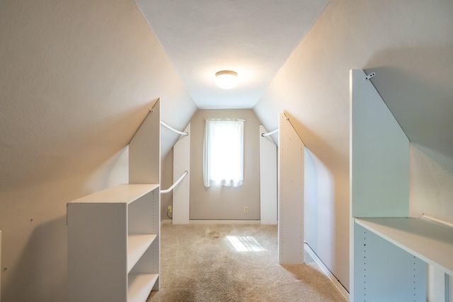 bonus room featuring lofted ceiling and carpet flooring