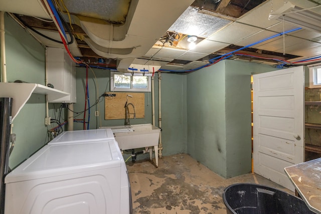 basement with washer / dryer and a sink