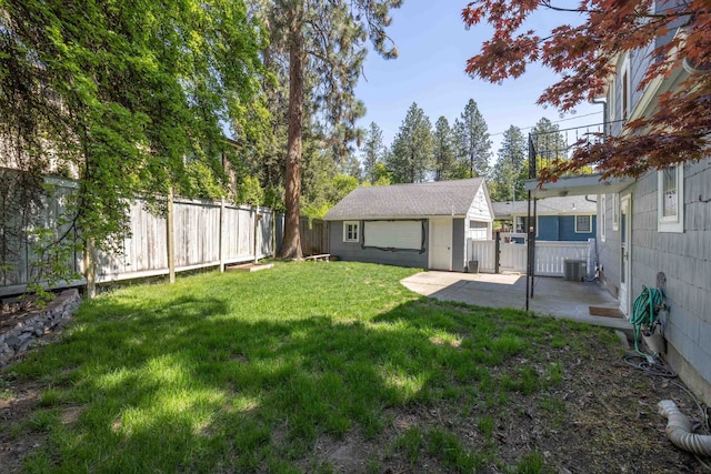 view of yard featuring central air condition unit, a patio area, an outdoor structure, and a fenced backyard