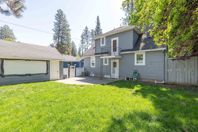 back of house featuring a lawn, a patio, and fence