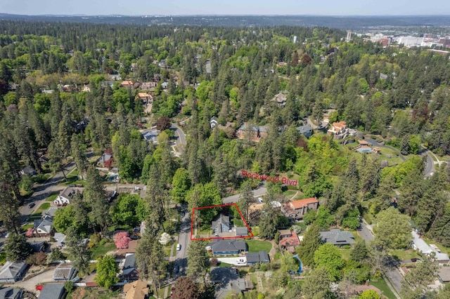 drone / aerial view featuring a forest view