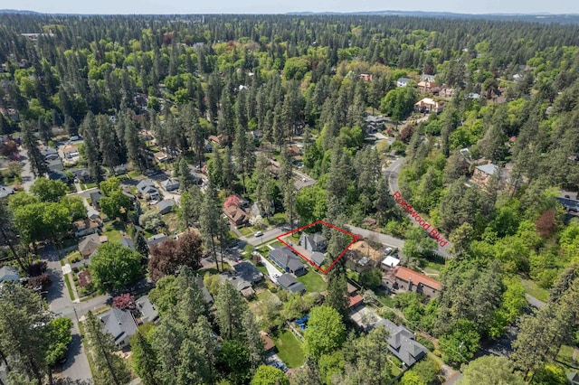 birds eye view of property featuring a wooded view