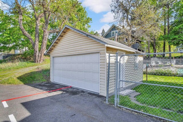 517 S Maple St, Spokane, WA 99204 - view of front of house with fence, a garage, and an outbuilding