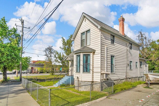 517 S Maple St, Spokane, WA 99204 - view of side of home with a chimney, a shingled roof, and fence private yard
