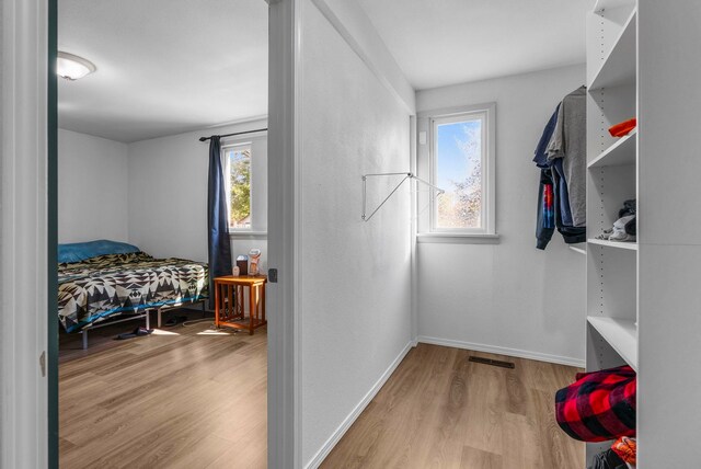 1815 E Longfellow Avenue 1817E. Longfellow Ave, Spokane, WA 99207 - walk in closet with visible vents and wood finished floors