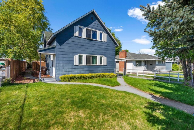 1815 E Longfellow Avenue 1817E. Longfellow Ave, Spokane, WA 99207 - rear view of house featuring a yard and fence