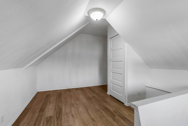 1815 E Longfellow Avenue 1817E. Longfellow Ave, Spokane, WA 99207 - additional living space with vaulted ceiling, wood finished floors, and baseboards