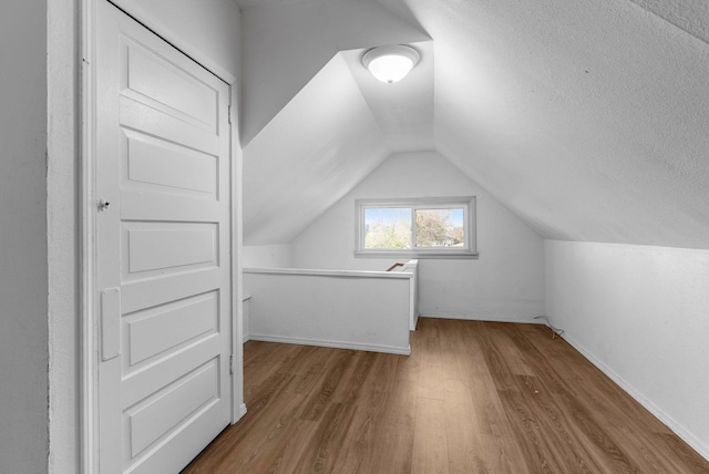 1815 E Longfellow Avenue 1817E. Longfellow Ave, Spokane, WA 99207 - additional living space featuring baseboards, wood finished floors, and lofted ceiling