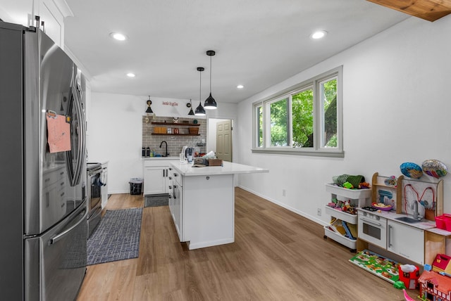 1815 E Longfellow Avenue 1817E. Longfellow Ave, Spokane, WA 99207 - kitchen with a sink, open shelves, white cabinetry, light countertops, and appliances with stainless steel finishes