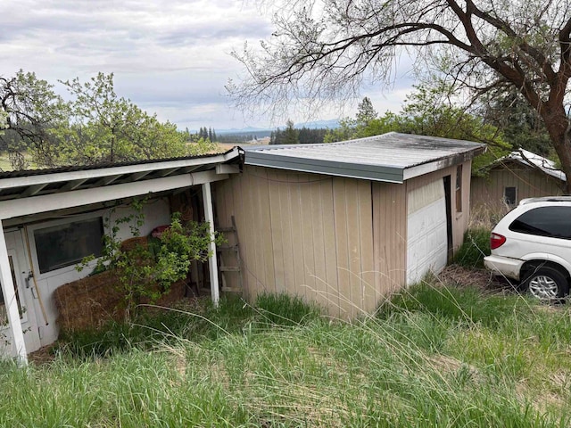 view of home's exterior with metal roof and a garage