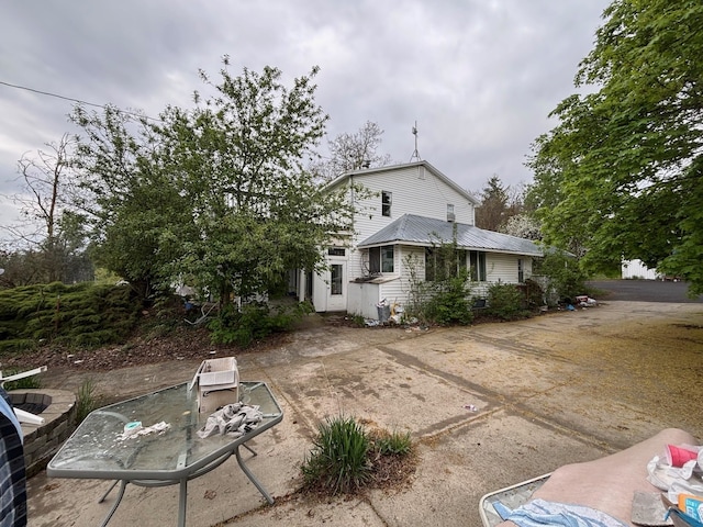 back of property featuring metal roof