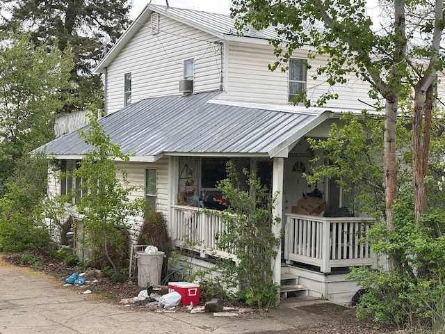 view of front of home featuring metal roof and a porch