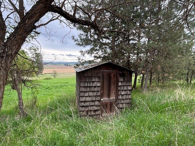 view of shed with a rural view