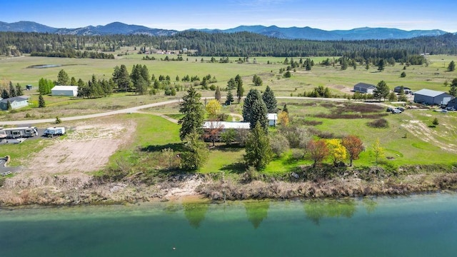 drone / aerial view featuring a water and mountain view and a rural view