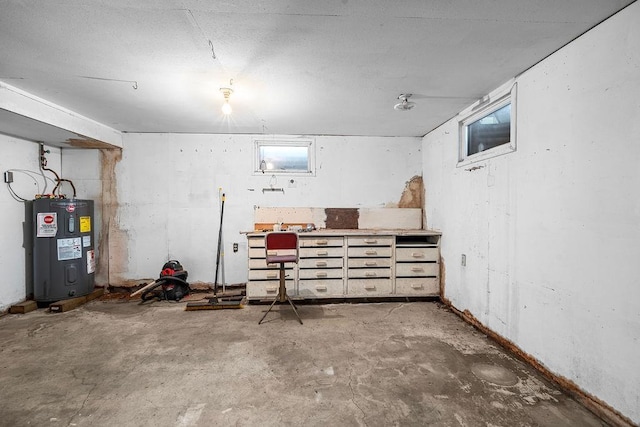 below grade area featuring a workshop area and electric water heater