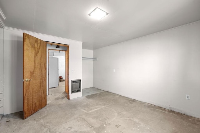 unfurnished bedroom with heating unit and concrete flooring