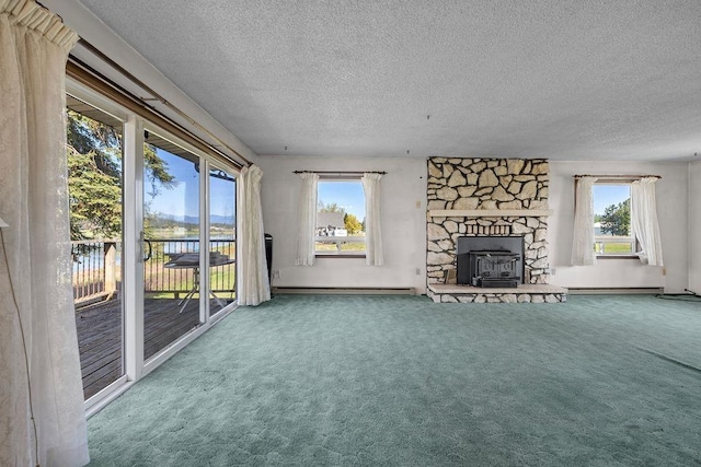 unfurnished living room featuring a textured ceiling, carpet floors, and a baseboard heating unit