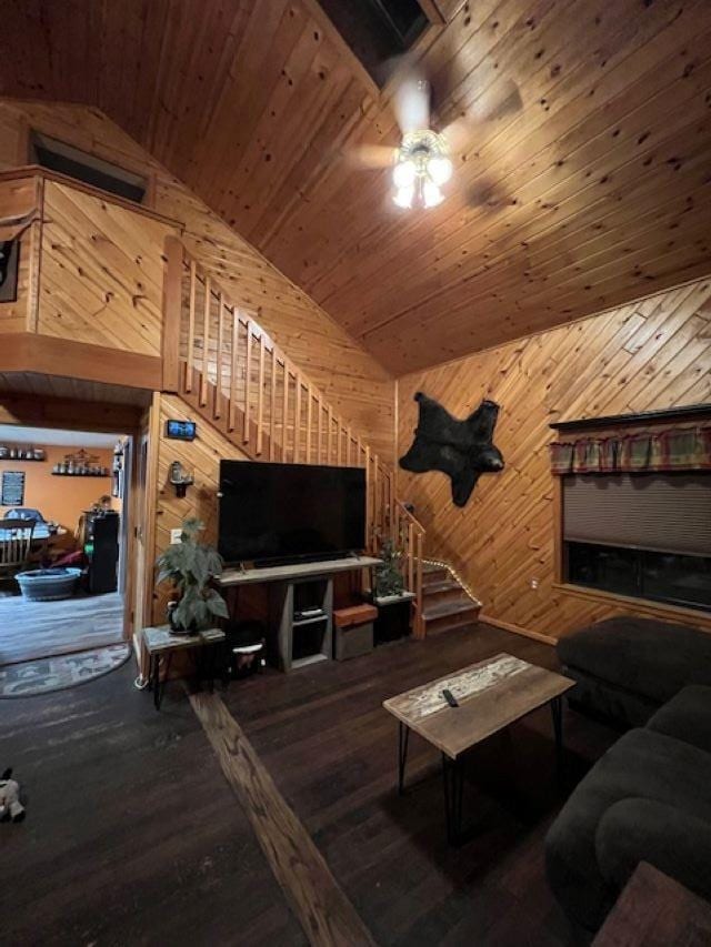 living area with vaulted ceiling, wood walls, wooden ceiling, and wood finished floors