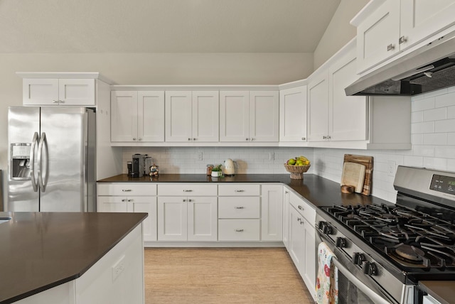 5718 N Vista Park Dr, Spokane, WA 99217 - kitchen featuring appliances with stainless steel finishes, under cabinet range hood, dark countertops, white cabinets, and decorative backsplash