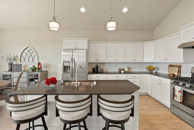 5718 N Vista Park Dr, Spokane, WA 99217 - kitchen with stainless steel appliances, dark countertops, decorative backsplash, white cabinets, and recessed lighting