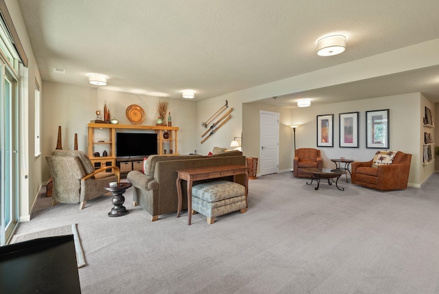 living area featuring baseboards and carpet flooring